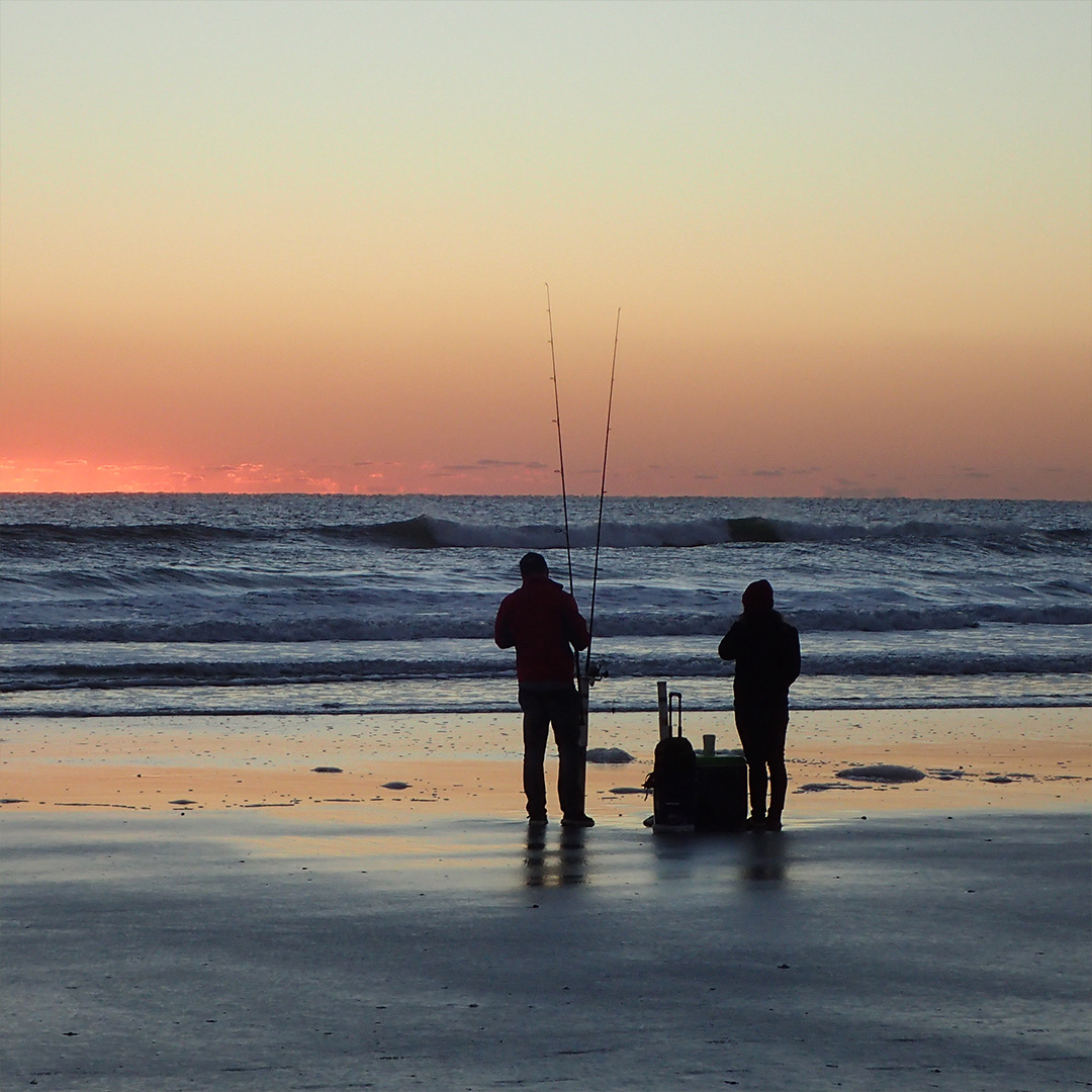 silhouette-people-beach-against-clear-sky-sunset